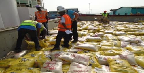 PGS surveyors in PPE conducting discharge tally supervision on yellow bagged cargo